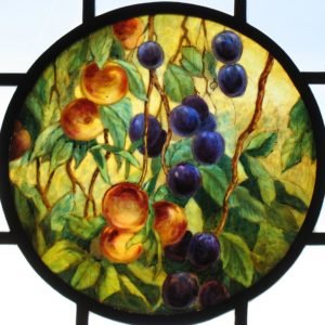 Painted glass roundel with peaches and plums as the subject.