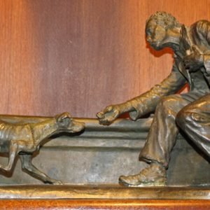 Bronze sculpture of a starving man feeding a starving dog.