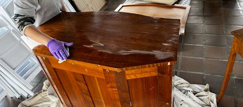 Michaela applying treatment to top of dresser