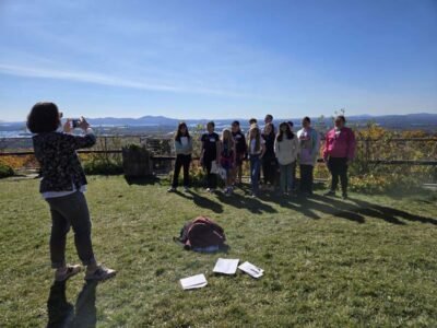 Teacher Taking Photo of Students with a view of Lake Winnipesaukee in the background